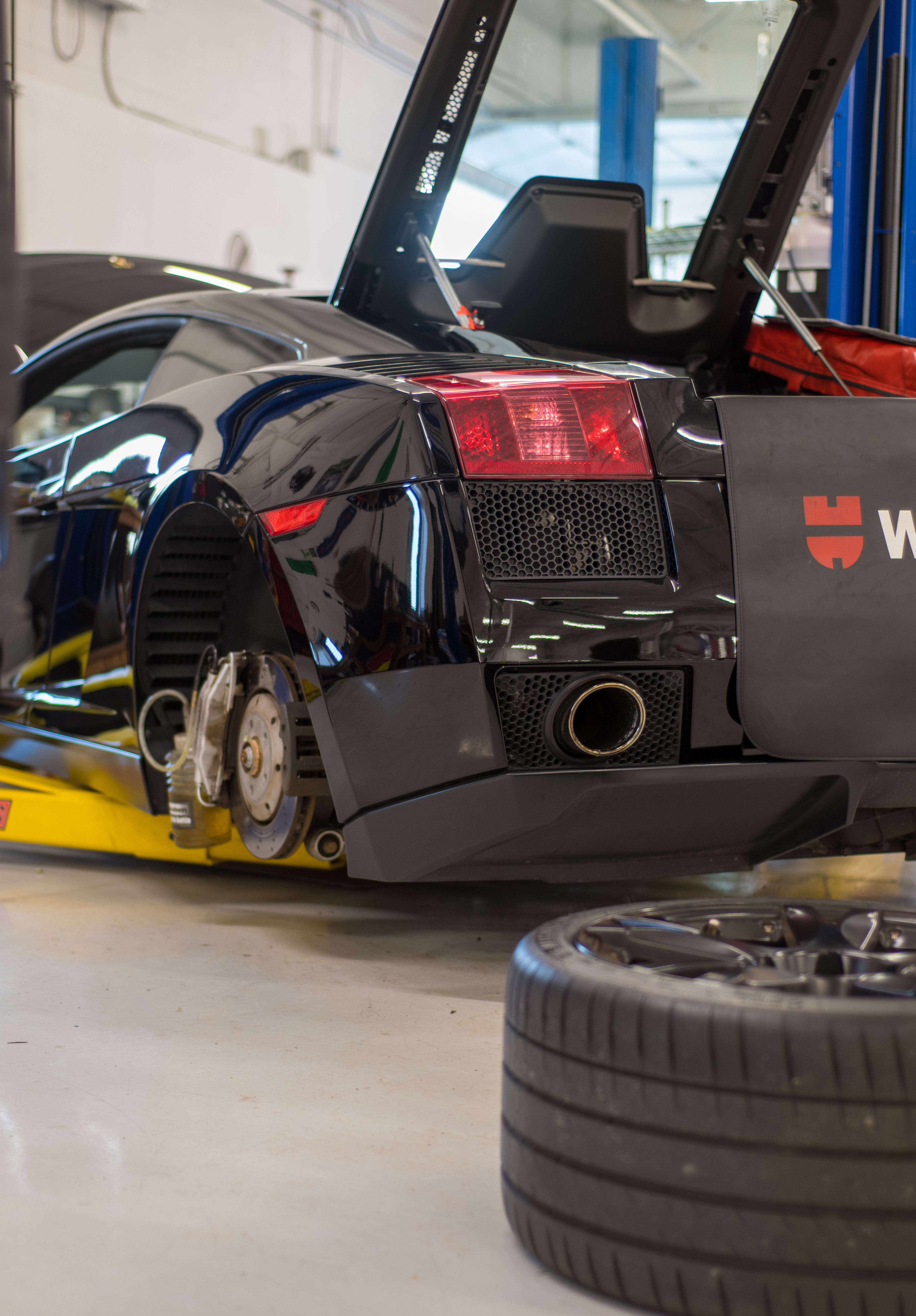 Lamborghini000 “Technician working on Lamborghini V10 engine”